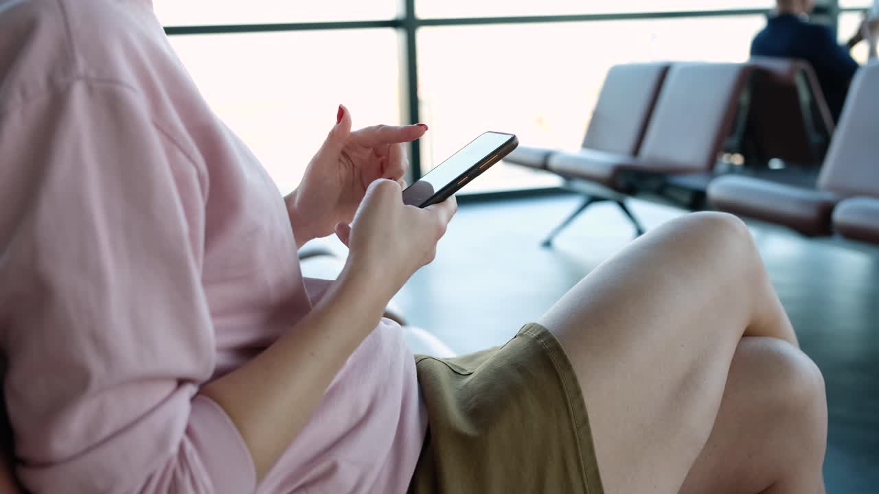 Woman using a phone in the airport terminal