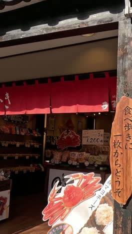 a person walks by a quaint japanese storefront.