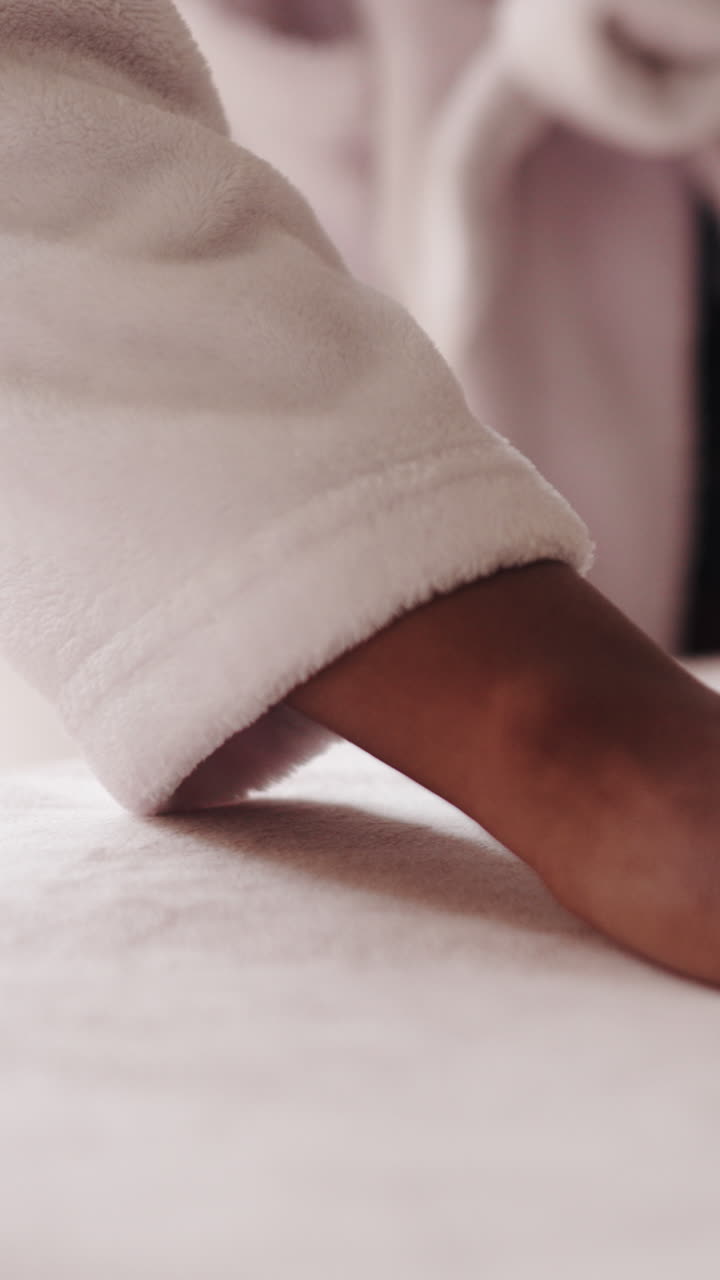 Close-up of a Woman's Hand Gently Touching Soft White Fabric