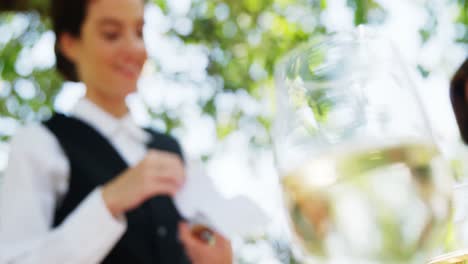 waitress taking an order from couples