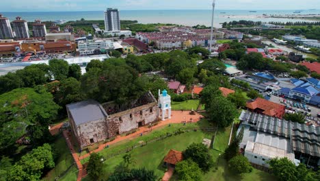 drone takes a counter clockwise rotation shot of the saint paul's church in malacca city, malaysia