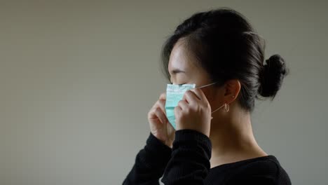 asian woman putting on face mask in slow motion b