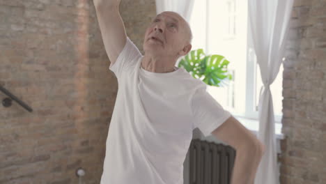 Old-Male-Stretching-And-Exercising-At-Home