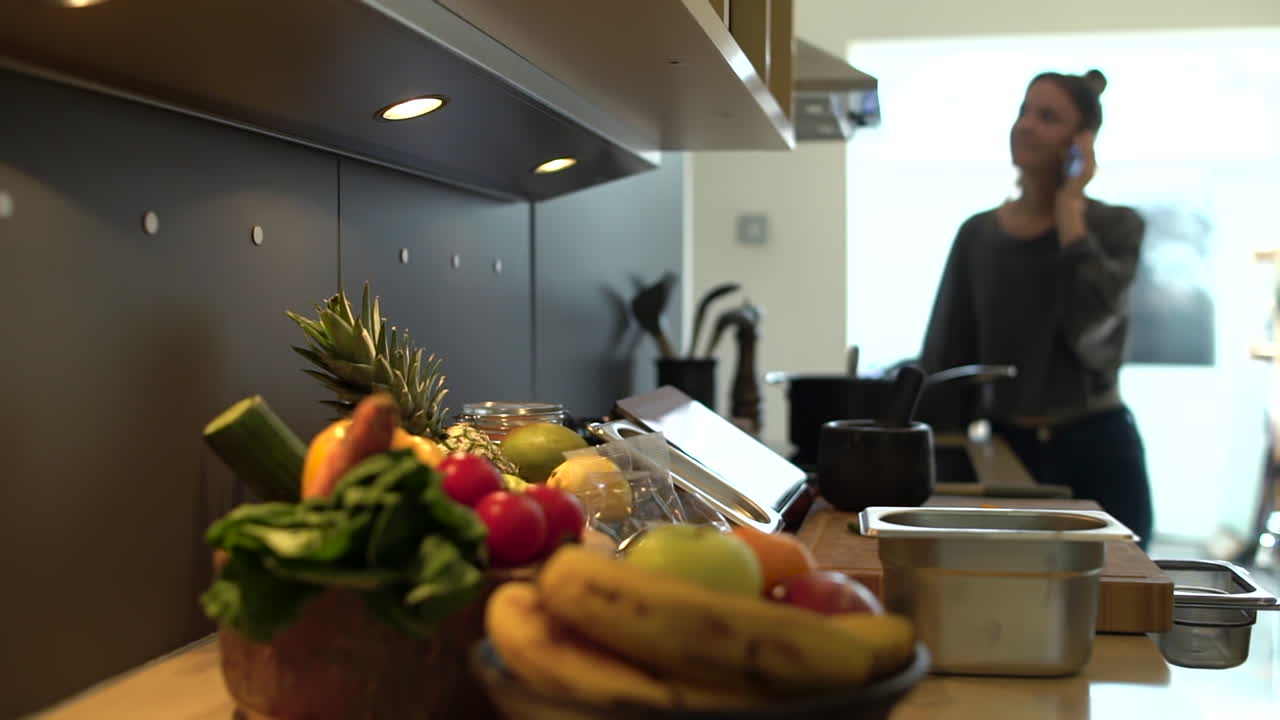 Pull Focus of Young Woman Cooking