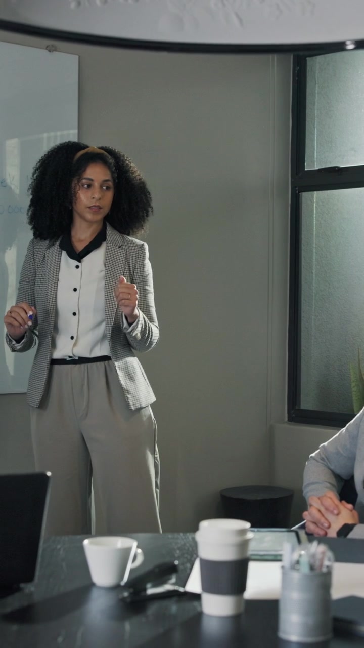 Businesswoman Giving a Presentation in a Modern Office Meeting
