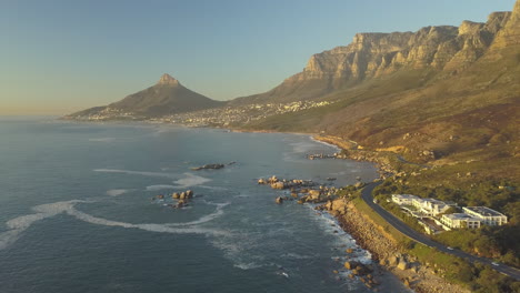 Scenic-wide-aerial-Drone-view-of-coastal-Oudekraal-Nature-Reserve,-Twelve-apostles-mountains,-South-Africa