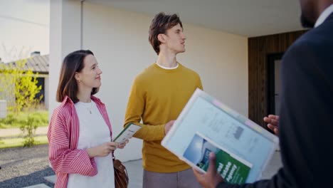 couple viewing a new house with real estate agent