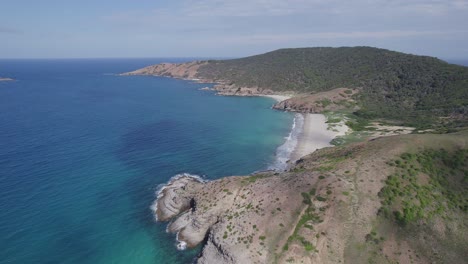 Touristic-Beach-On-Wreck-Bay,-Great-Keppel-Island-In-Queensland,-Australia---aerial-pullback