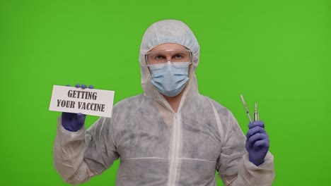 doctor with syringe, ampoule and text slogan on paper safe your life get vaccinated, coronavirus