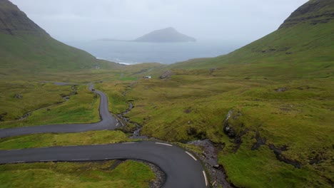 aerial above woman walking in nordadalsskard, streymoy, faroe islands