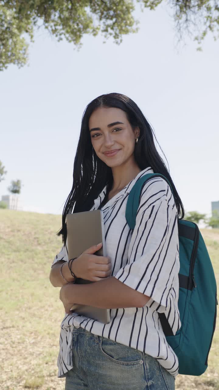 Smiling Student with Laptop Outdoors