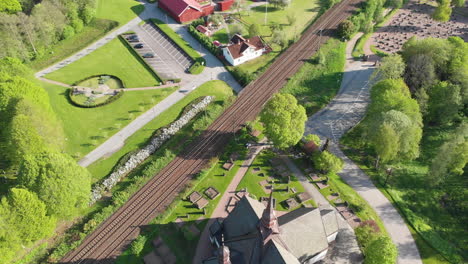 4k aerial footage overhead looking down at railway and church in the town of lerum,vastra gotaland, sweden