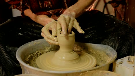 professional male potter making mug in pottery workshop