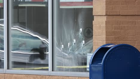 Bullet-holes-in-the-glass-after-a-mass-shooting-in-Buffalo,-New-York,-United-States,-at-a-Tops-Friendly-Markets-store,-supermarket-in-the-East-Side-neighborhood