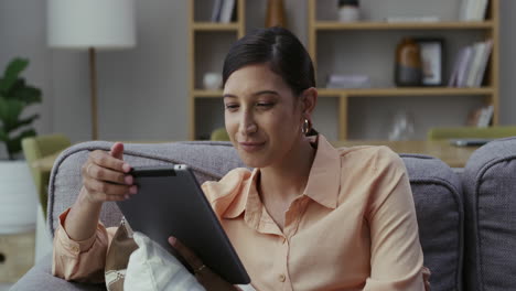 Woman-on-tablet,-sitting-and-reading-ebook