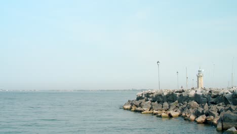 lighthouse of desenzano del garda with rocky coastline on lake