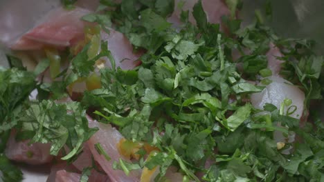 putting coriander on the fish for the ceviche