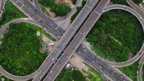 maduravoyal bridge with trees, road and vehicles at maduravoyal bypass flyover, mumbai highway, maduravoyal, chennai, tamil nadu, india. day time, top down with spin shot, push down, drone shot, 4k.