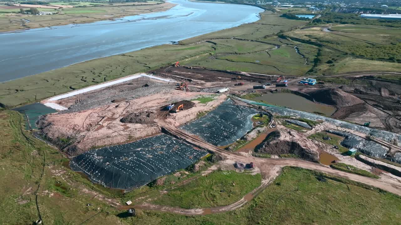 Ugly Landfill Site Next To River Wyre With Working Vehicles And Scavenging Seagulls. Jameson Road Landfill And Recycling Site, Fleetwood, UK