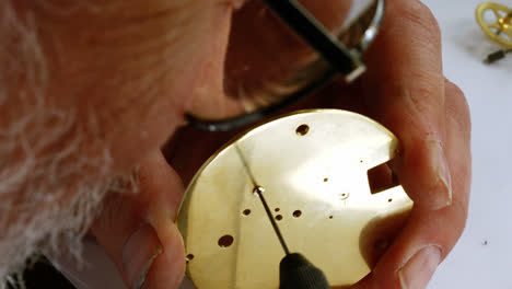 horologist repairing a pocket watch