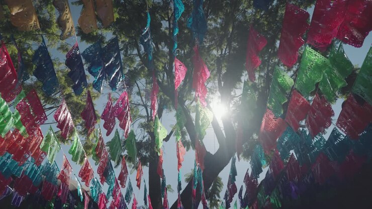 Colorful Papel Picado Decorations Hanging from a Tree