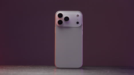 back of a white smartphone with multiple cameras
