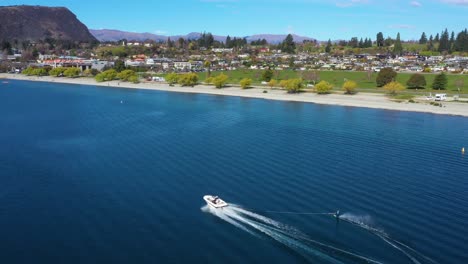 aerial over a water skier water skiing on lake wakatipu in the south island of new zealand