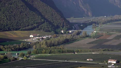 aerial view of vineyards and river valley in the italian alps