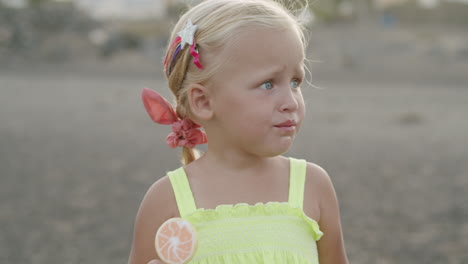 it is hard to bite the lollipop but she did it