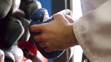 mid-section of man wearing boxing gloves