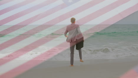 animation of caucasian businessman by sea over flag of usa