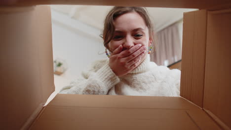 Happy-young-woman-shopper-unpacking-cardboard-box-delivery-parcel-online-shopping-purchase-at-home