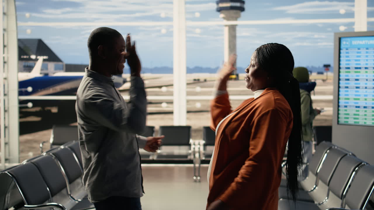 Humorous parents share high-five saying goodbye to teenager at the airport
