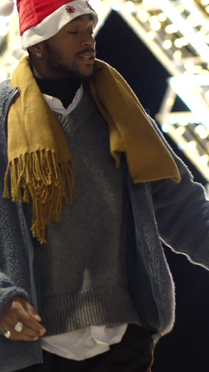 Man in Christmas Hat Near City Lights