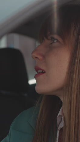 worried woman turns head to side examining road condition. fastened female driver sits in car waiting out heavy traffic jam cleared closeup slow motion