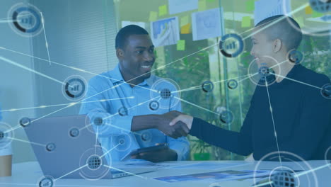 animation of connected icons with lines over multiracial coworkers shaking hands in office
