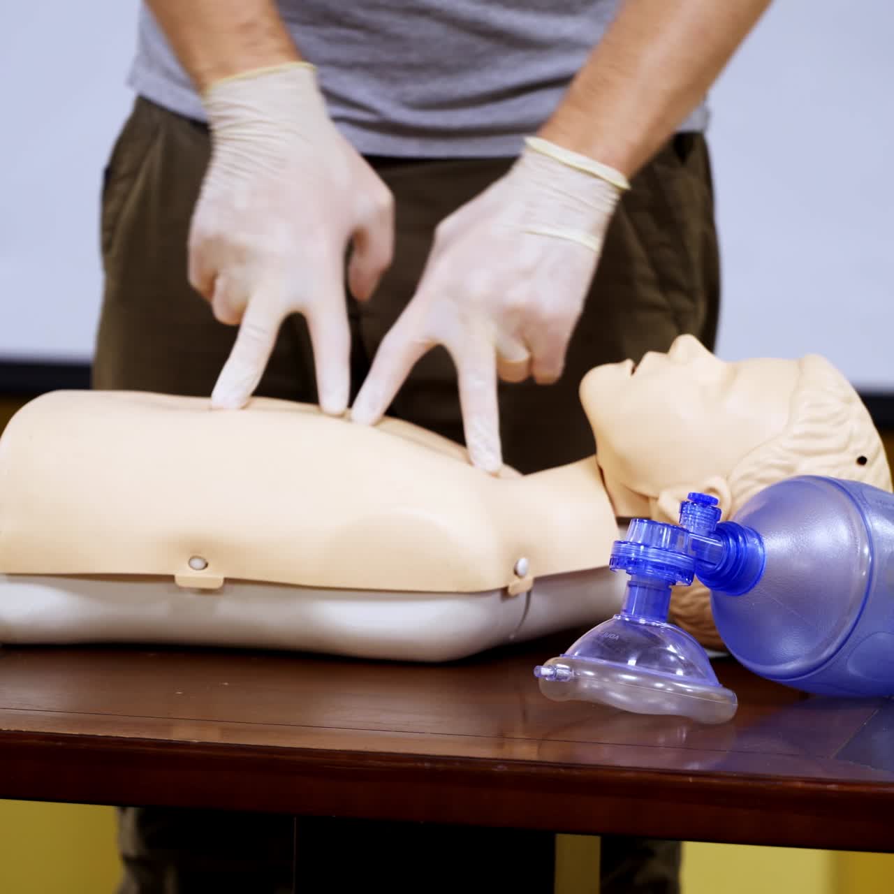 Medical male dummy lays on training table in hall. Medical equipments for first aid education. Courses for giving necessary health help