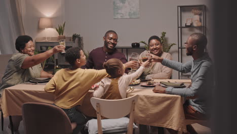 happy family toasting during dinner