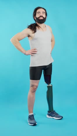 man with a prosthetic leg standing confidently against a blue background