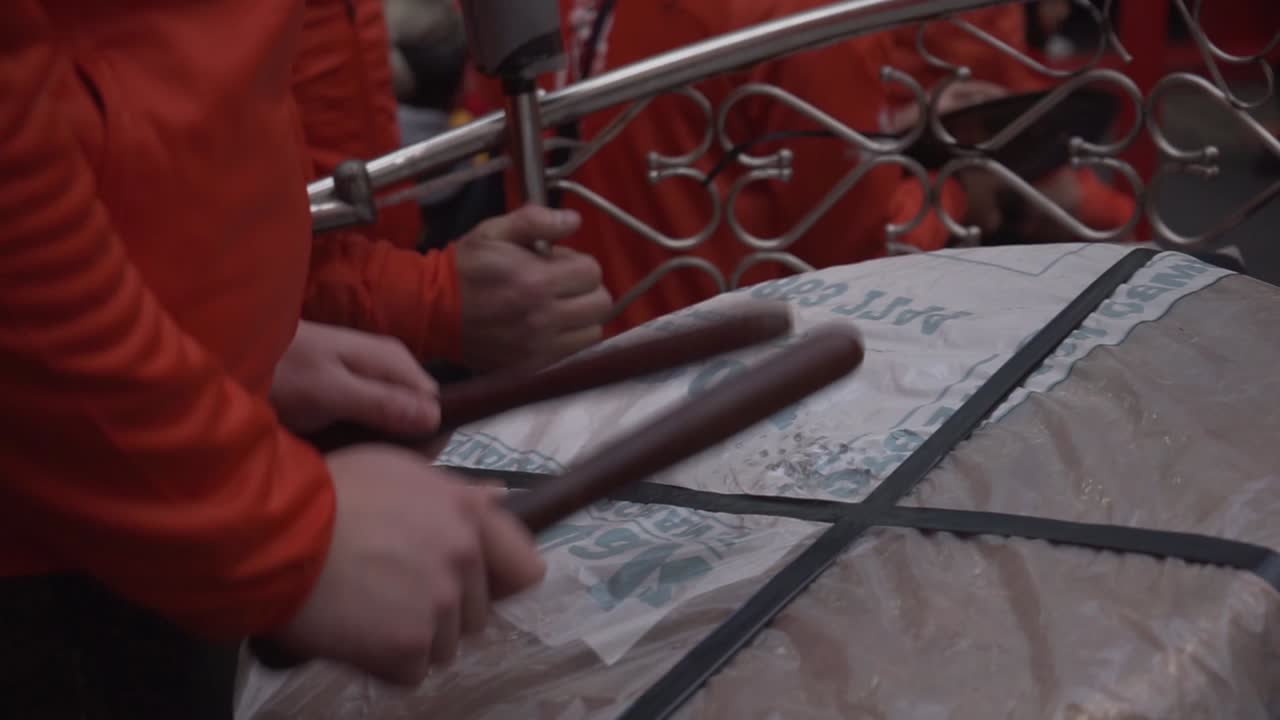 Close view of a man playing the drum percusion making loud noise in chinese new year celebration in china town london england 2020