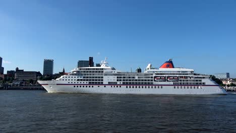 cruise liner in hamburg on departure, elbe and cityscape,