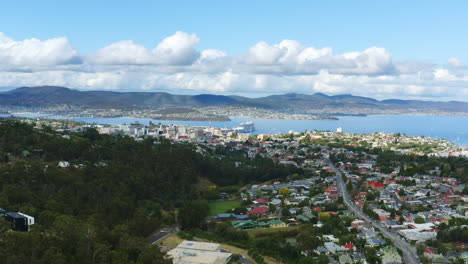 aerial drone flyover hobart tasmania city buildings with afternoon shade, 4k slow motion