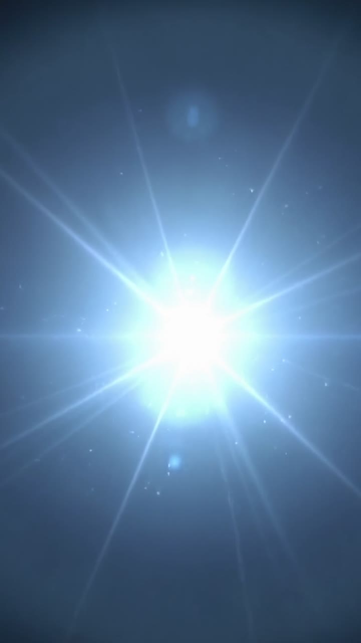 Vertical video: Emerging bluish-white point light growing in void, expanding halo, rays and ghosts