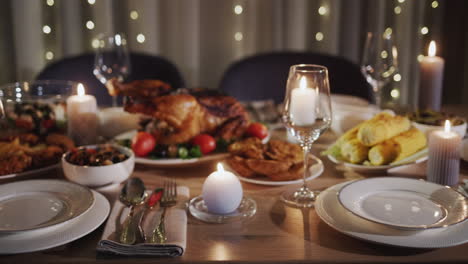 thanksgiving holiday table with turkey in the center of the table