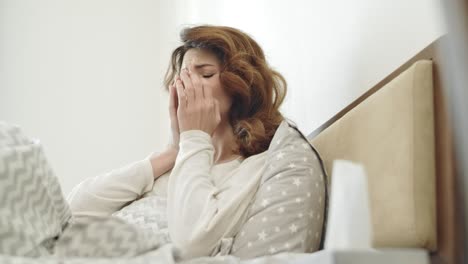 pretty woman having cough lying in bed. sick woman getting throat cold.