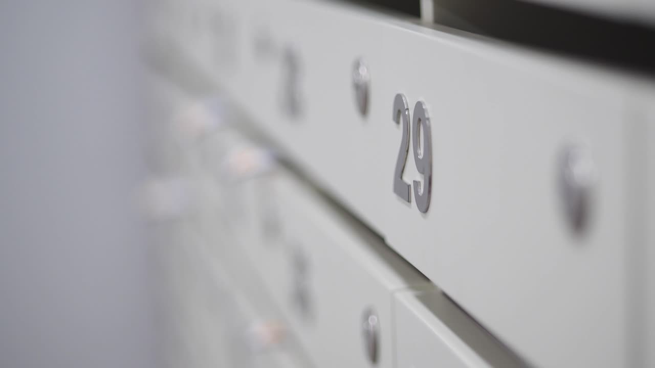 Close-up of a bank of white mailboxes with the number 29 in focus
