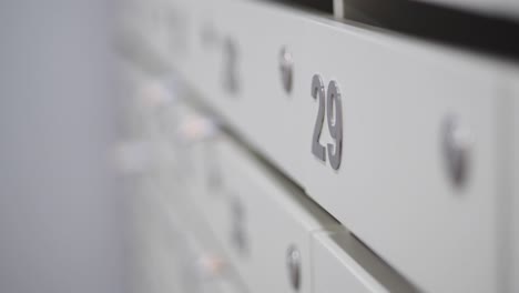 close-up of a bank of white mailboxes with the number 29 in focus