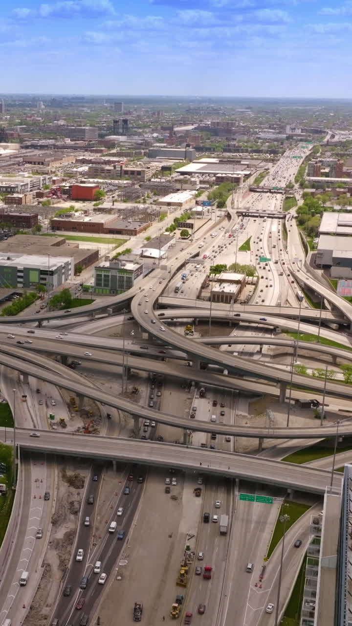 Stunning road system in Chicago, Illinois. Multiple highways, roundabouts and loops at the traffic of metropolis. Beautiful city panorama from above. Vertical video