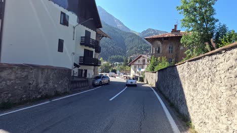 a car drives through a picturesque italian village