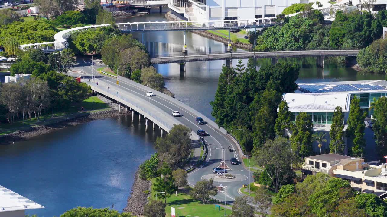 Aerial view of vehicles crossing a bridge over the Nerang River in Gold Coast, Australia, under clear daylight